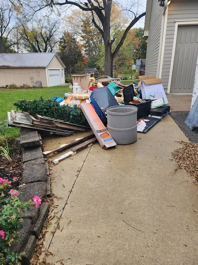 Dumpster being loaded with debris for Roofing Dumpster Rental in Roslyn